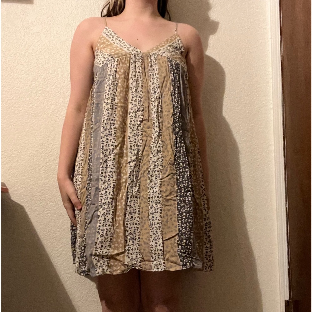Bêcool sundress. beige, white, and gray with floral design and v cut neckline.